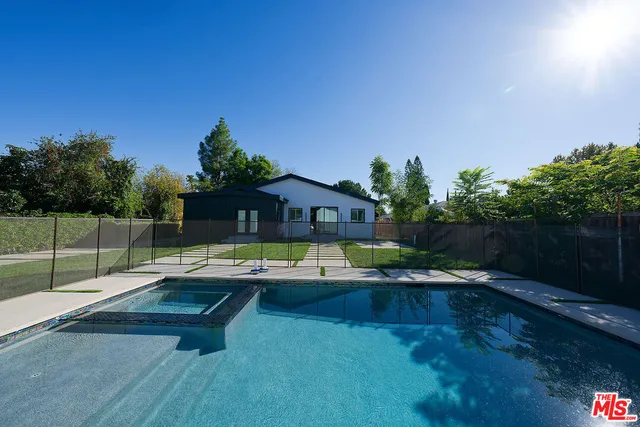 a front view of a house with yard and green space
