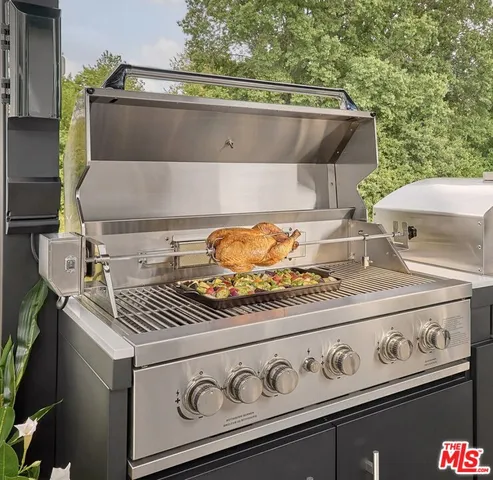a stove top oven sitting next to a yard