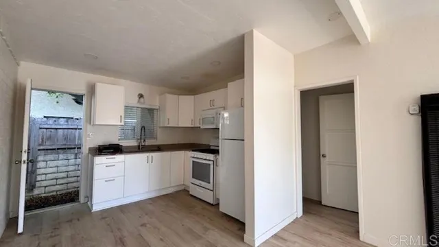 a kitchen with stainless steel appliances granite countertop a stove and a refrigerator