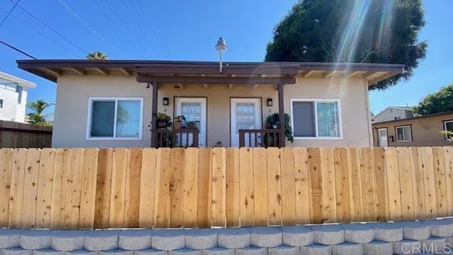 a view of a blue door with a wooden fence