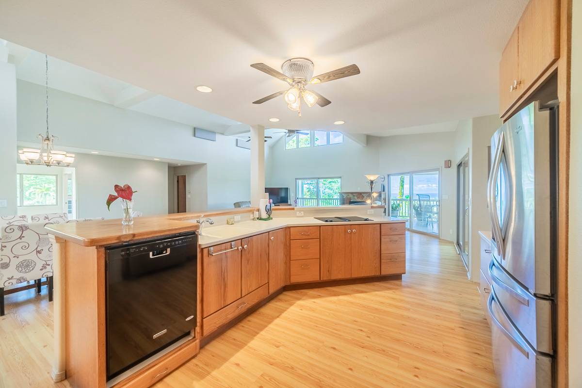 370 Akolea Road Hilo, HI 96720 - Photo 11 of 29 a kitchen with stainless steel appliances granite countertop a sink stove and refrigerator