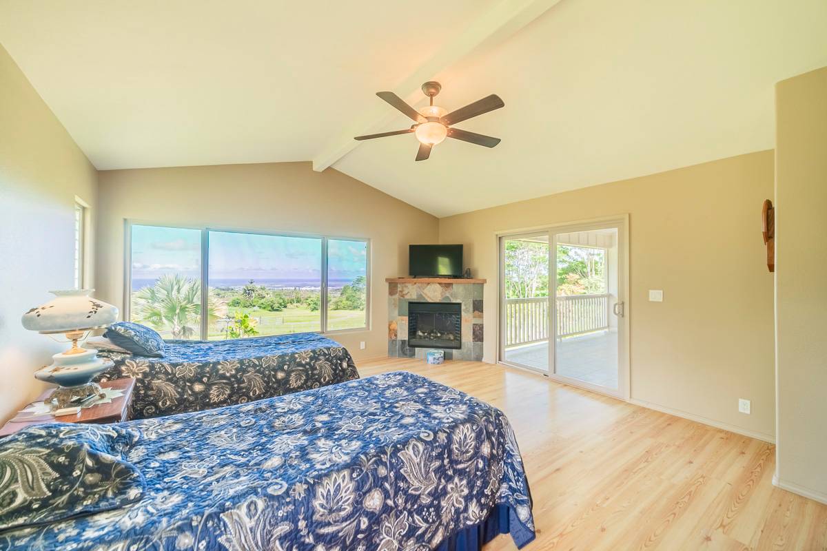 370 Akolea Road Hilo, HI 96720 - Photo 14 of 29 a bed sitting in a spacious bedroom next to a window