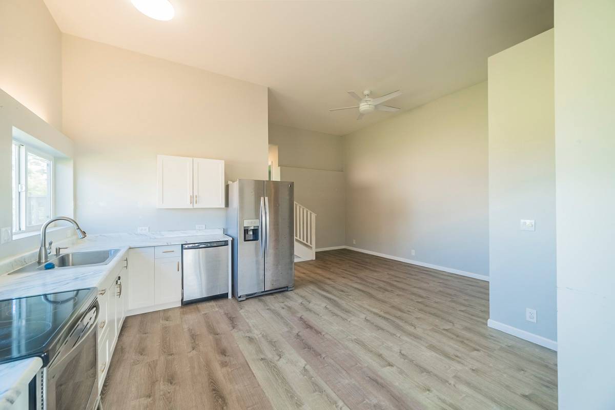 370 Akolea Road Hilo, HI 96720 - Photo 21 of 29 a kitchen with a sink refrigerator and cabinets