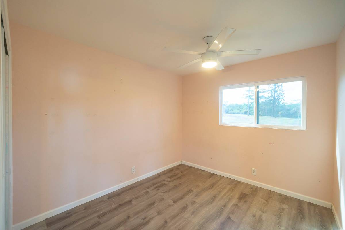 370 Akolea Road Hilo, HI 96720 - Photo 22 of 29 an empty room with wooden floor and windows
