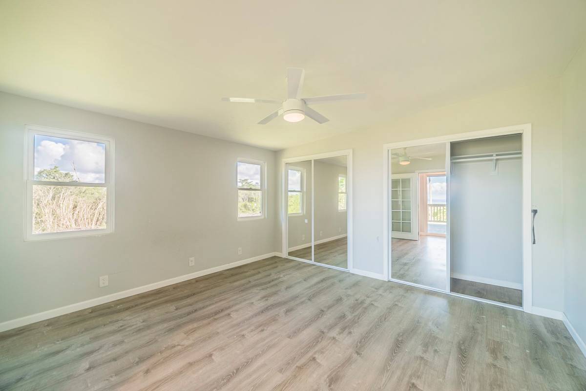 370 Akolea Road Hilo, HI 96720 - Photo 24 of 29 wooden floor in an empty room with a window