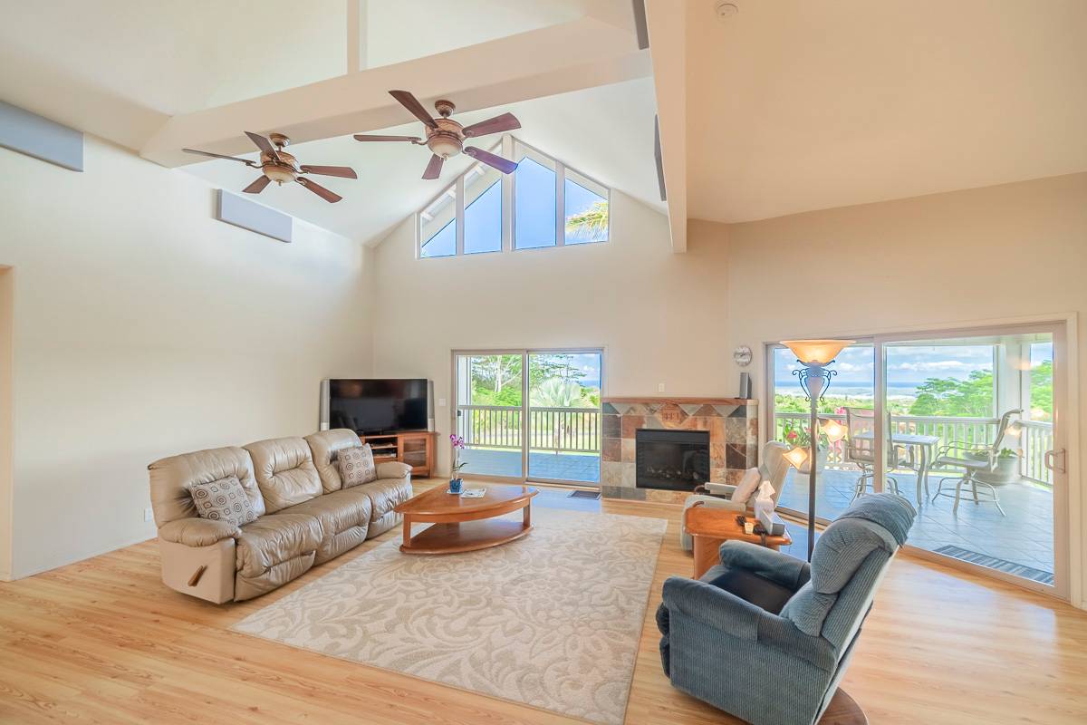 370 Akolea Road Hilo, HI 96720 - Photo 8 of 29 a living room with furniture fireplace and a flat screen tv