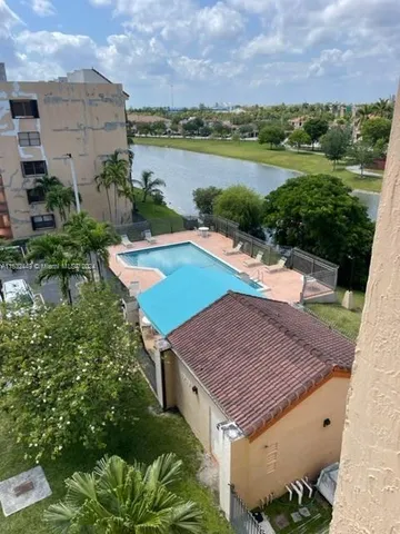 an aerial view of a house with a yard and outdoor seating
