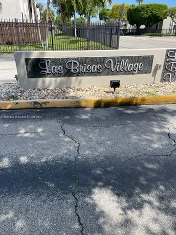 a view of a water fountain with wooden fence