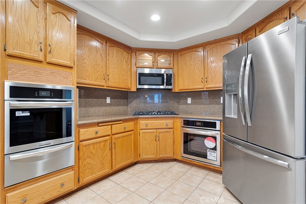 16620 Iwa Road Apple Valley, CA 92307 - Photo 12 of 50 a kitchen with stainless steel appliances granite countertop a refrigerator sink and microwave