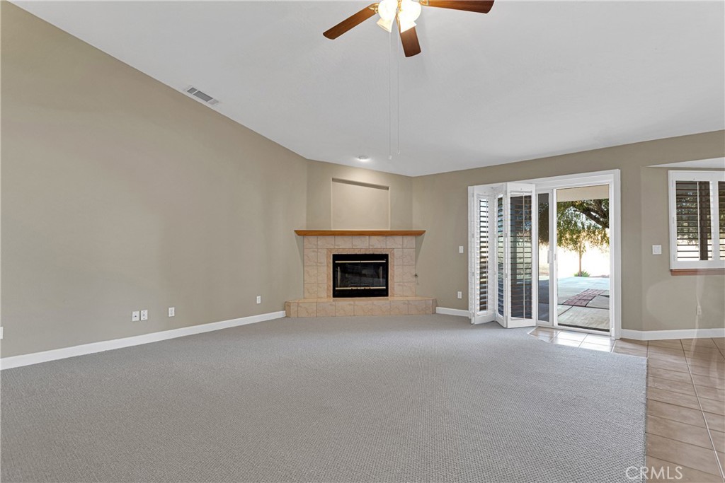 16620 Iwa Road Apple Valley, CA 92307 - Photo 14 of 50 an empty room with ceiling fan and windows