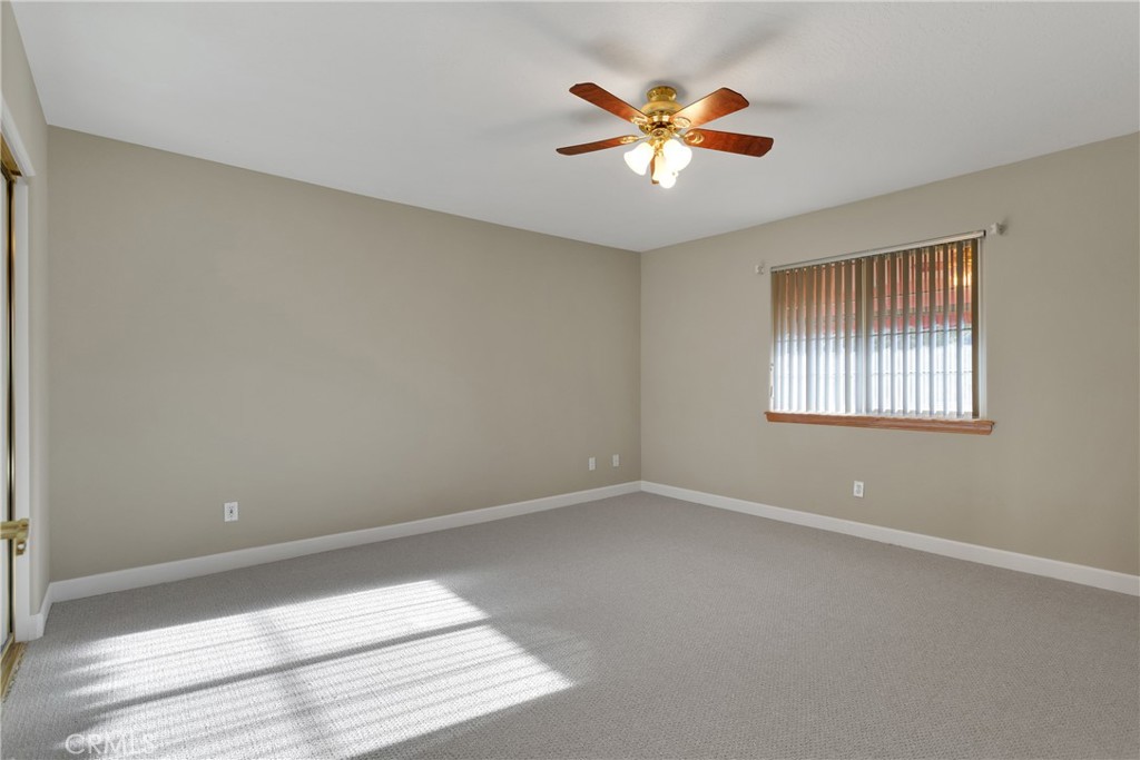 16620 Iwa Road Apple Valley, CA 92307 - Photo 22 of 50 an empty room with windows and ceiling fan