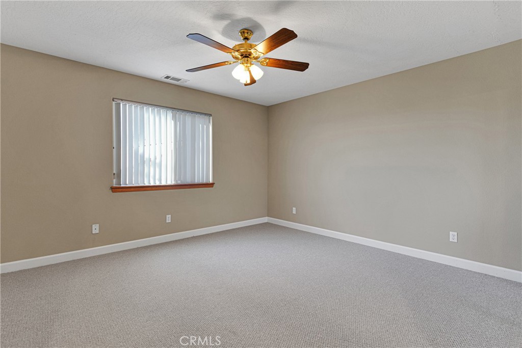 16620 Iwa Road Apple Valley, CA 92307 - Photo 26 of 50 an empty room with window and chandelier fan
