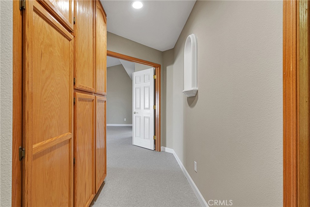 16620 Iwa Road Apple Valley, CA 92307 - Photo 28 of 50 a view of a hallway with wooden shelves