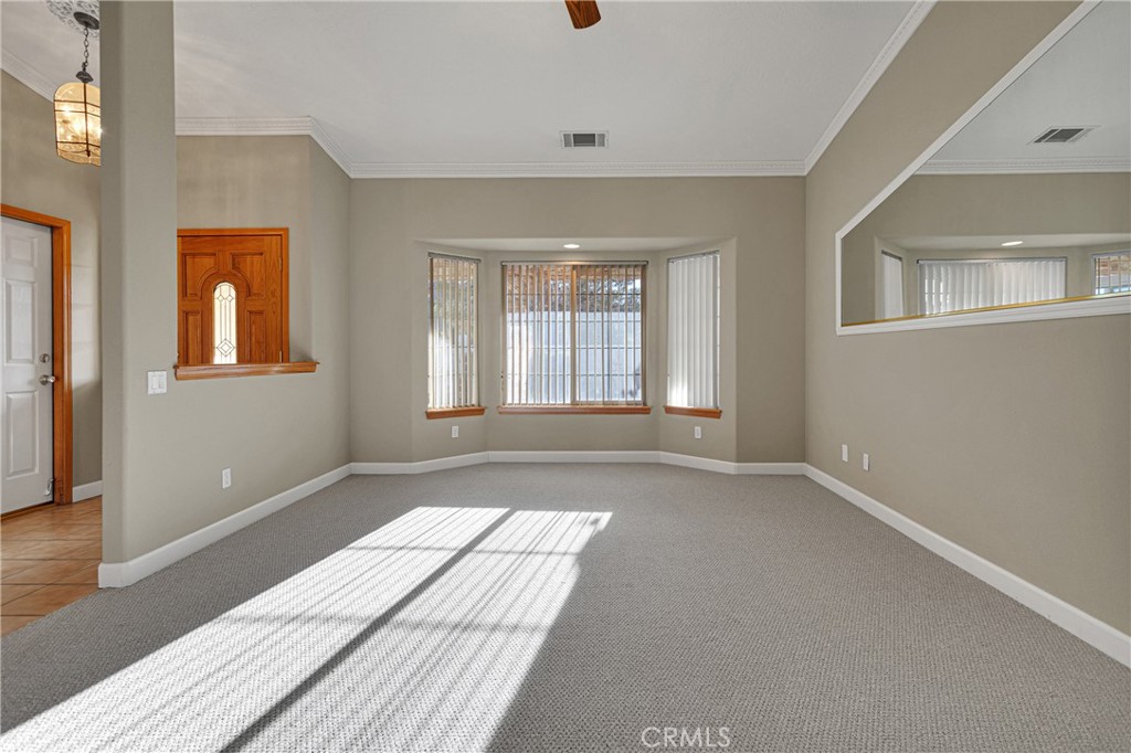 16620 Iwa Road Apple Valley, CA 92307 - Photo 6 of 50 a view of an empty room with window and wooden floor