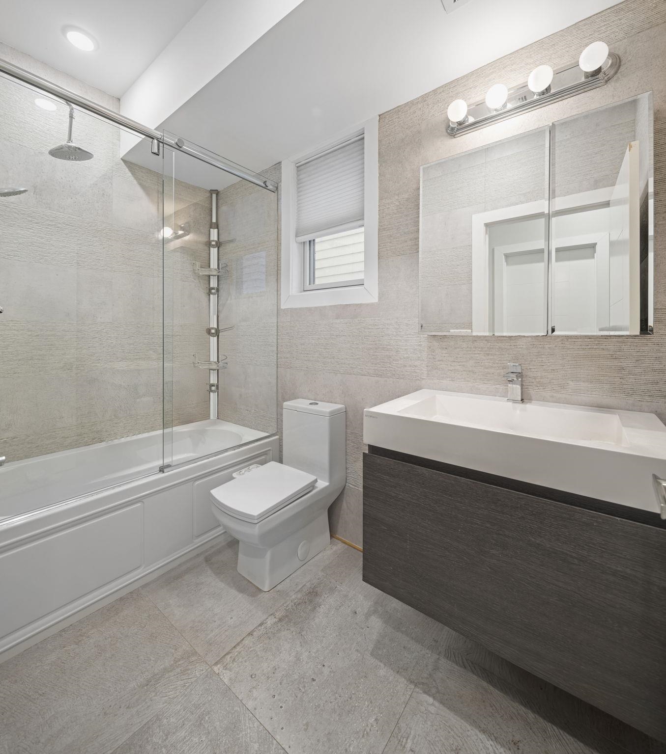 27 Hackensack Plank Road, Unit 1 Weehawken, NJ 07086 - Photo 11 of 23 a bathroom with a sink a toilet and shower