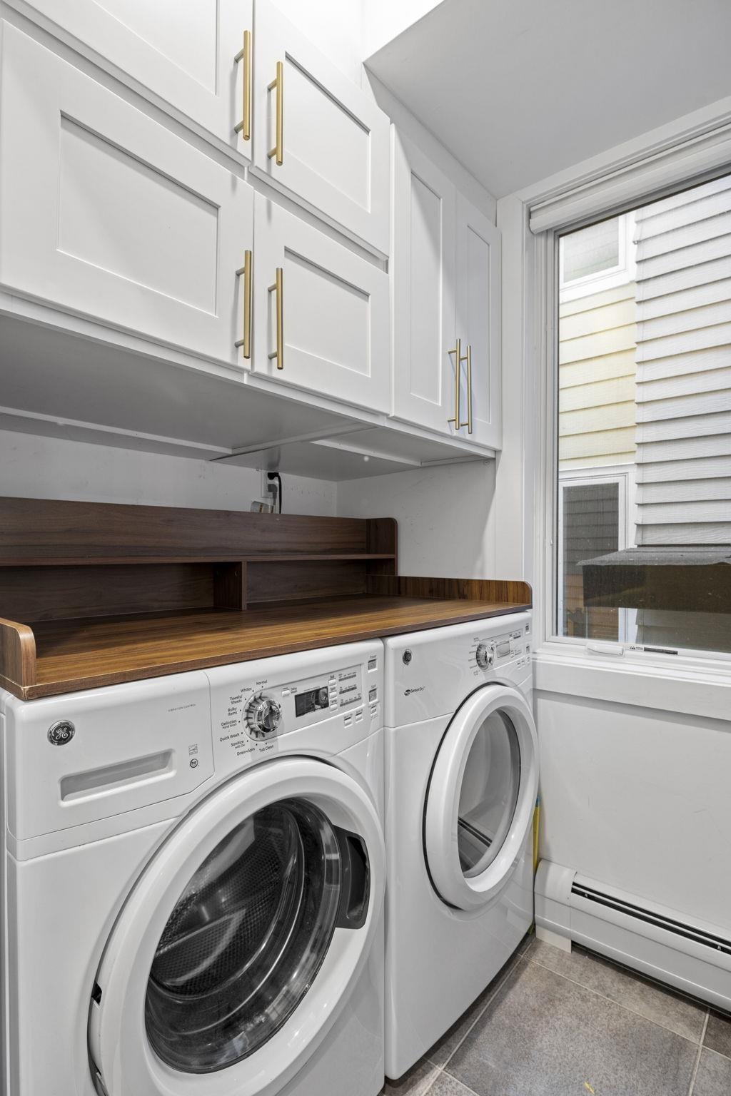 27 Hackensack Plank Road, Unit 1 Weehawken, NJ 07086 - Photo 12 of 23 a close up view of a washer and dryer in a kitchen