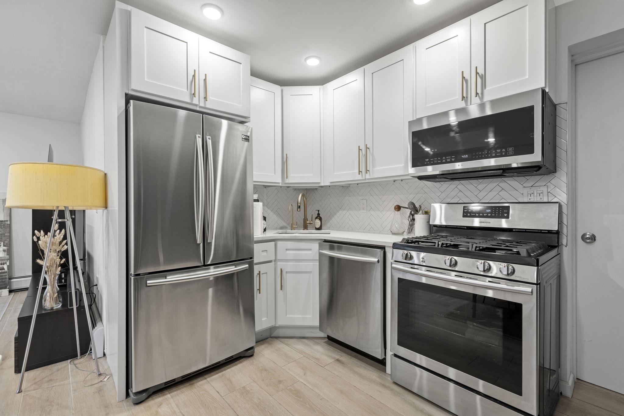 27 Hackensack Plank Road, Unit 1 Weehawken, NJ 07086 - Photo 20 of 23 a kitchen with stainless steel appliances a refrigerator sink and microwave
