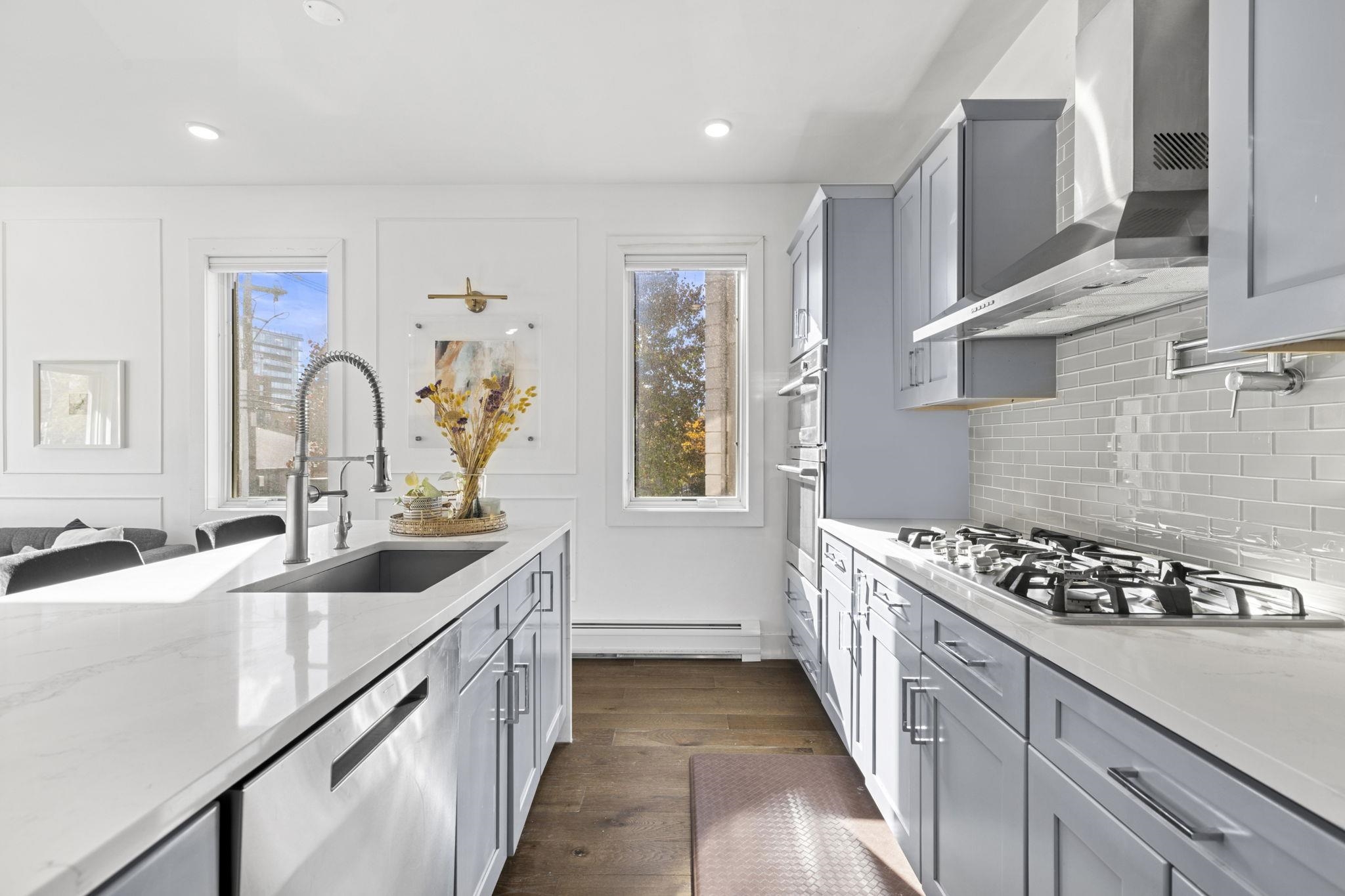 27 Hackensack Plank Road, Unit 1 Weehawken, NJ 07086 - Photo 2 of 23 a kitchen with granite countertop a sink stove and cabinets