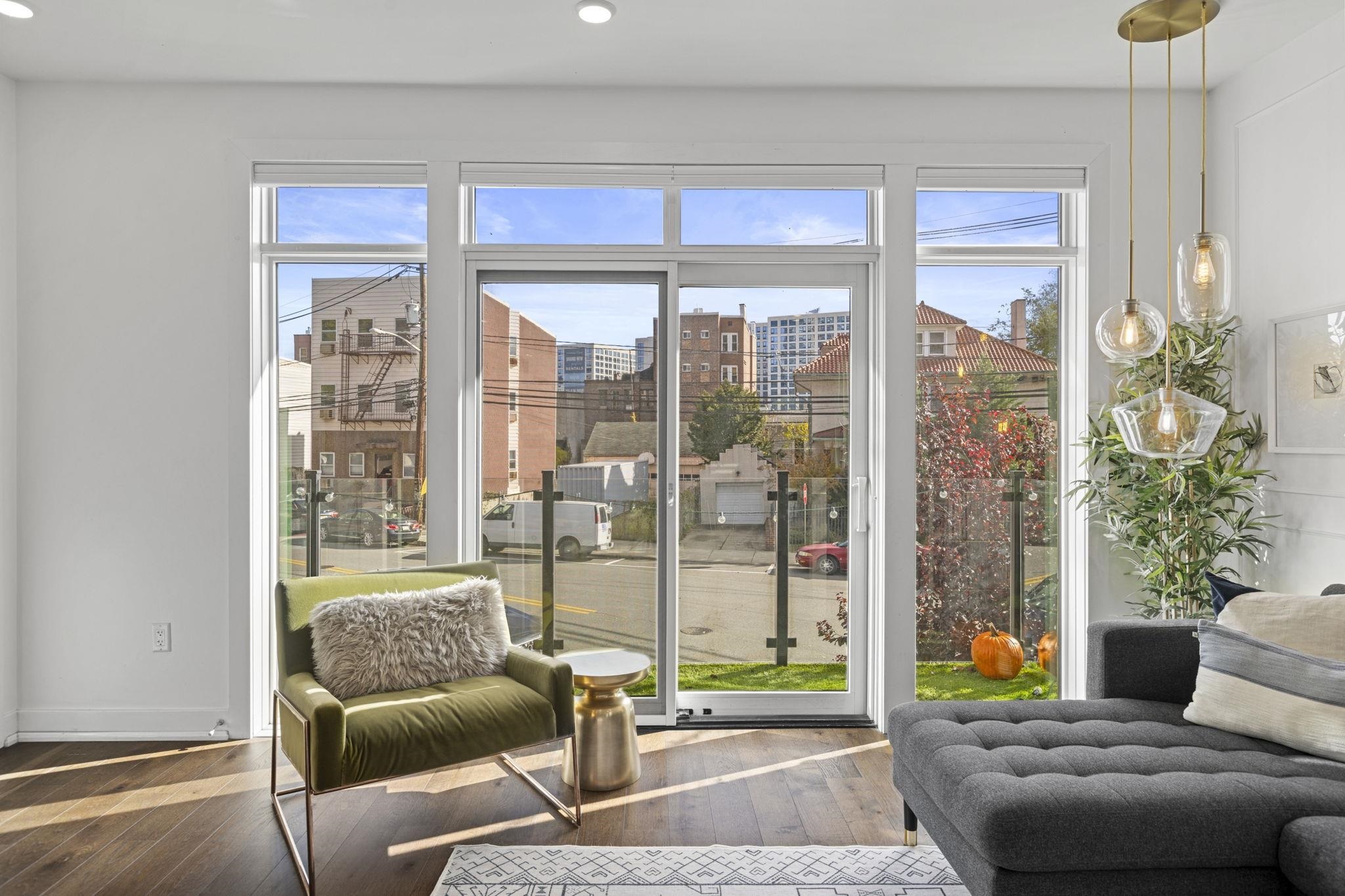 27 Hackensack Plank Road, Unit 1 Weehawken, NJ 07086 - Photo 5 of 23 a living room with furniture and a floor to ceiling window