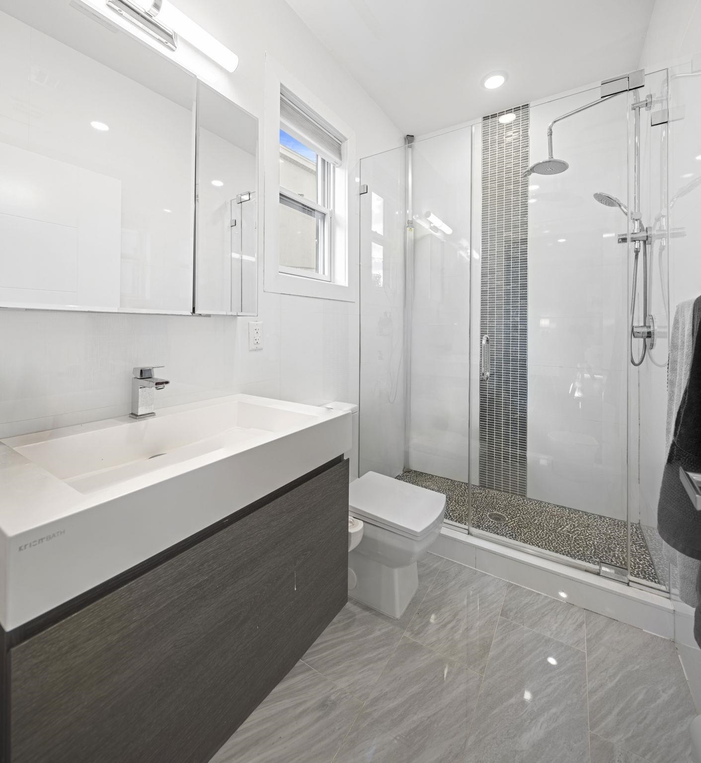 27 Hackensack Plank Road, Unit 1 Weehawken, NJ 07086 - Photo 8 of 23 a bathroom with a sink a toilet and shower