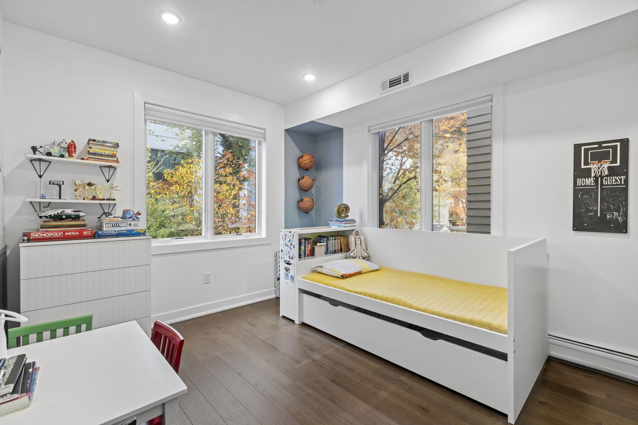 27 Hackensack Plank Road, Unit 1 Weehawken, NJ 07086 - Photo 9 of 23 a living room with baby bed furniture and a window