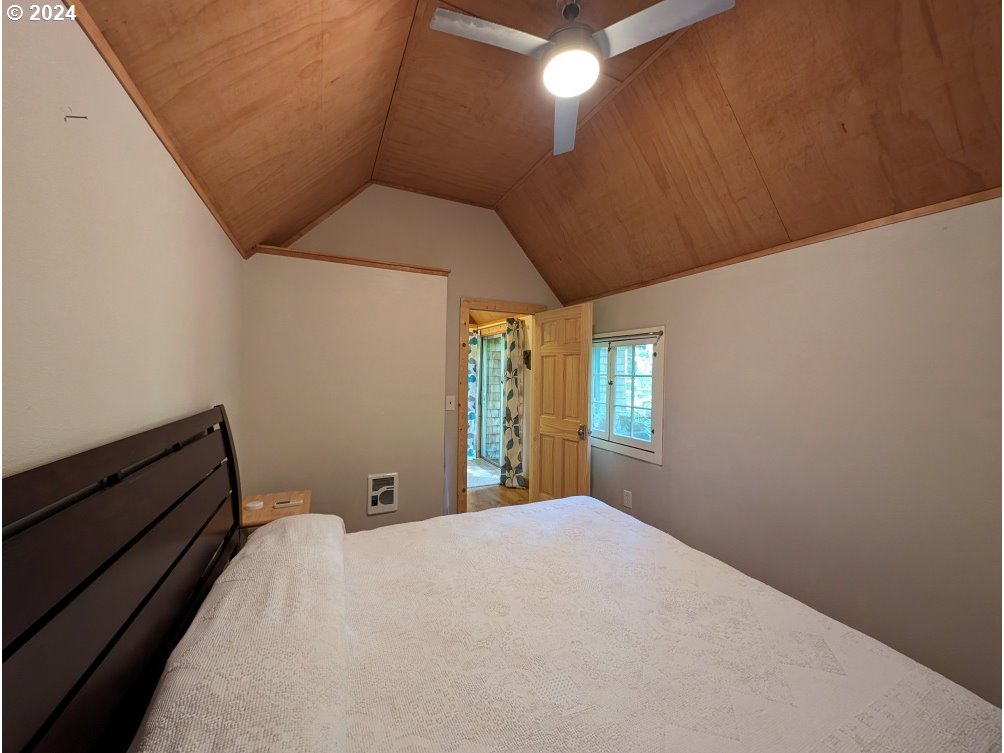 28018 Still Creek Road Rhododendron, OR 97049 - Photo 21 of 36 a bed room with a bed and a window