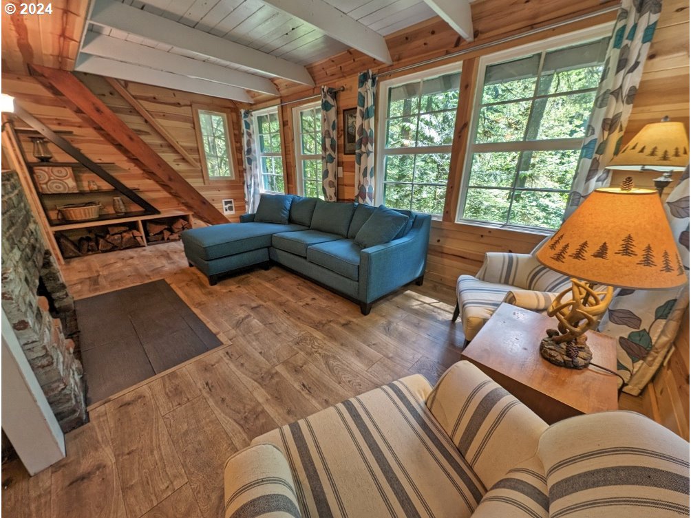 28018 Still Creek Road Rhododendron, OR 97049 - Photo 8 of 36 a living room with furniture and a large window