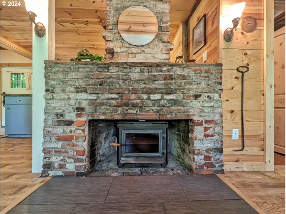28018 Still Creek Road Rhododendron, OR 97049 - Photo 10 of 36 a stone house with fireplace