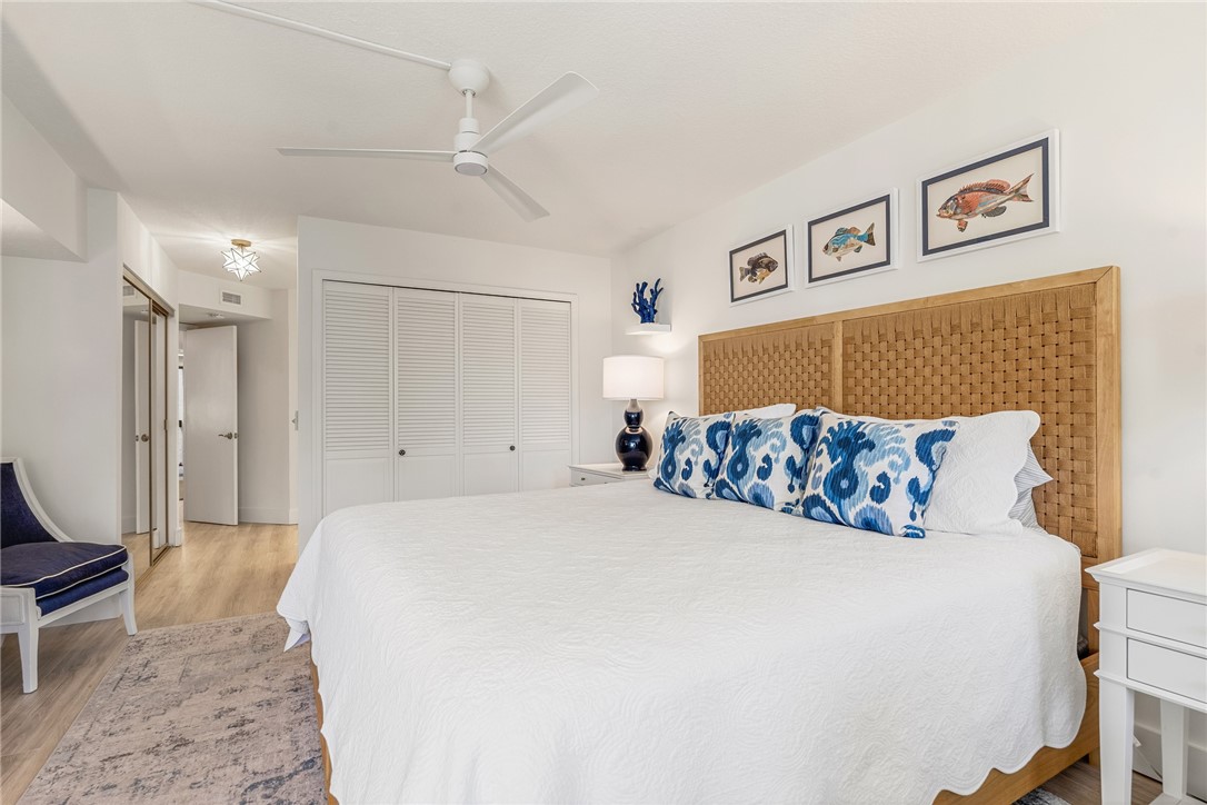 5101 Florida A1A, Unit 108 Vero Beach, FL 32963 - Photo 12 of 31 a large bed sitting in a bedroom and painting on the wall