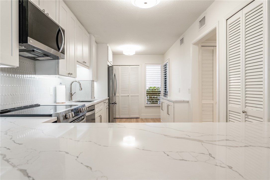 5101 Florida A1A, Unit 108 Vero Beach, FL 32963 - Photo 18 of 31 a view of a kitchen with furniture and windows