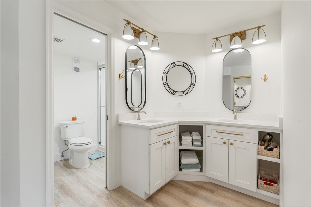 5101 Florida A1A, Unit 108 Vero Beach, FL 32963 - Photo 23 of 31 a spacious bathroom with a toilet a double vanity sink and a mirror
