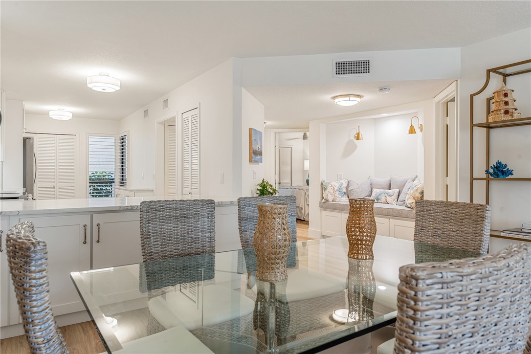 5101 Florida A1A, Unit 108 Vero Beach, FL 32963 - Photo 9 of 31 a view of kitchen with granite countertop dining table and chairs