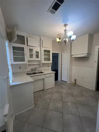 a kitchen with a stove cabinets and counter space