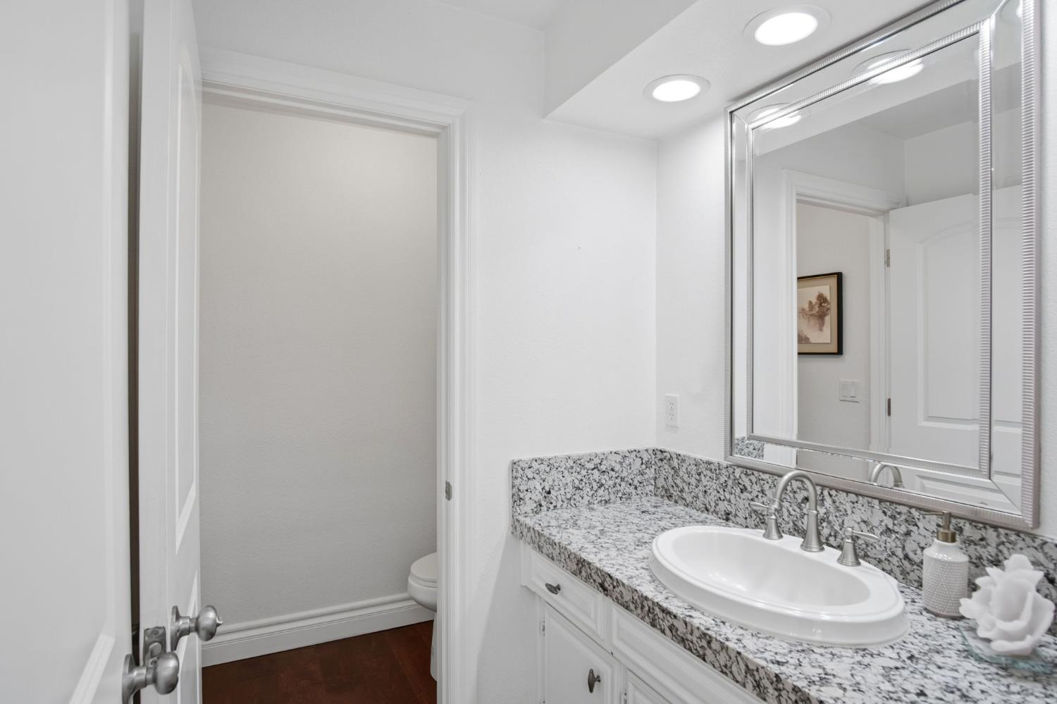 10401 Golf Link Road Turlock, CA 95380 - Photo 24 of 63 a bathroom with a granite countertop sink and a mirror