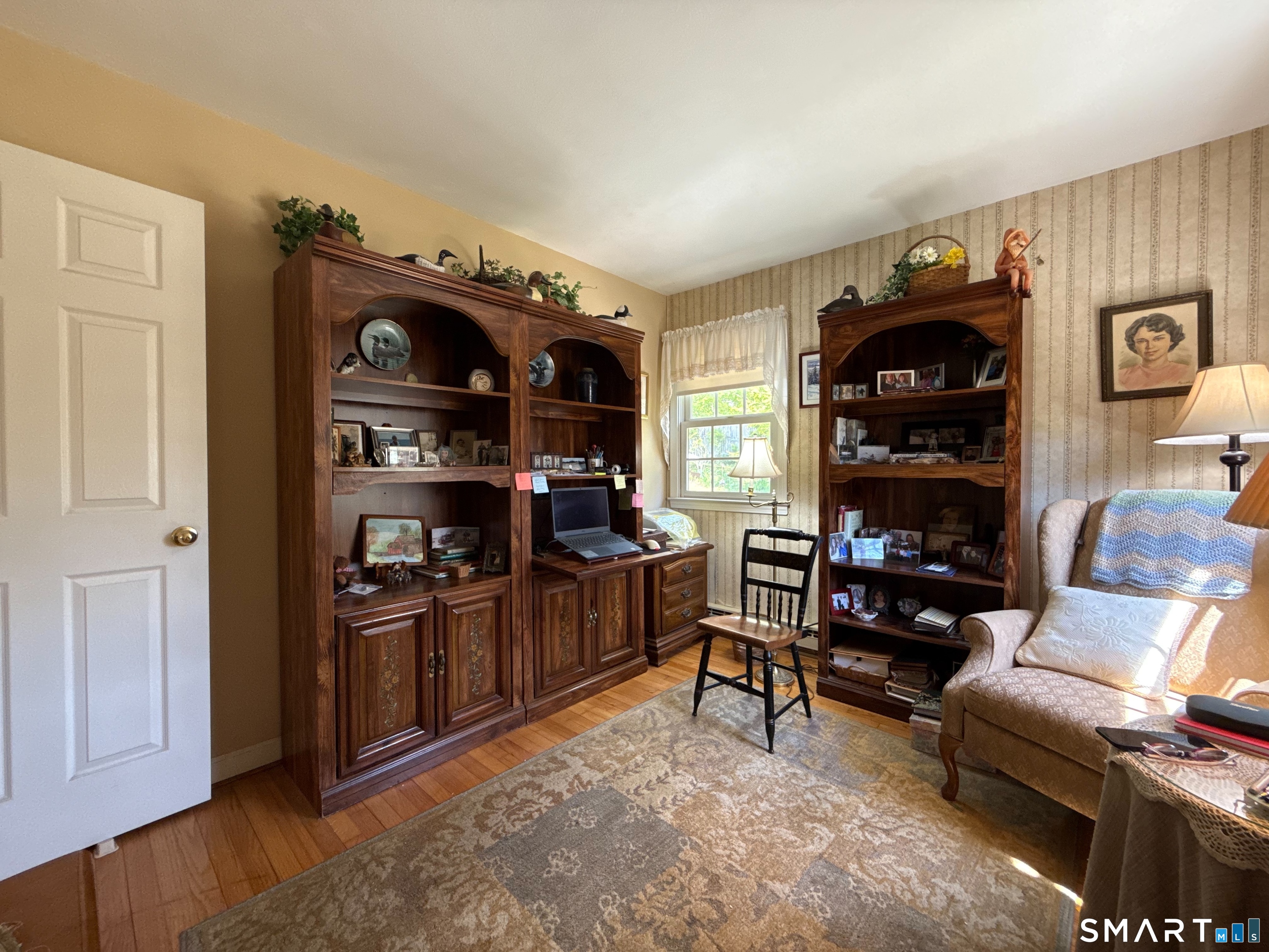 15 Grove Street Deep River, CT 06417 - Photo 17 of 25 a living room with furniture cabinets and a wooden floor