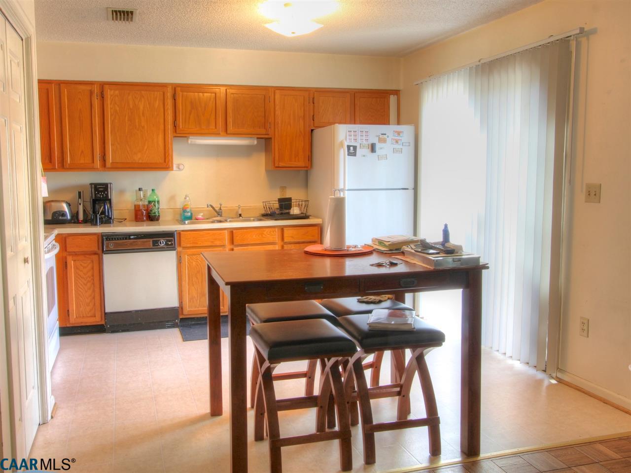 310 Westfield Road Charlottesville, VA 22901 - Photo 6 of 19 a kitchen with stainless steel appliances wooden floor and chairs in it