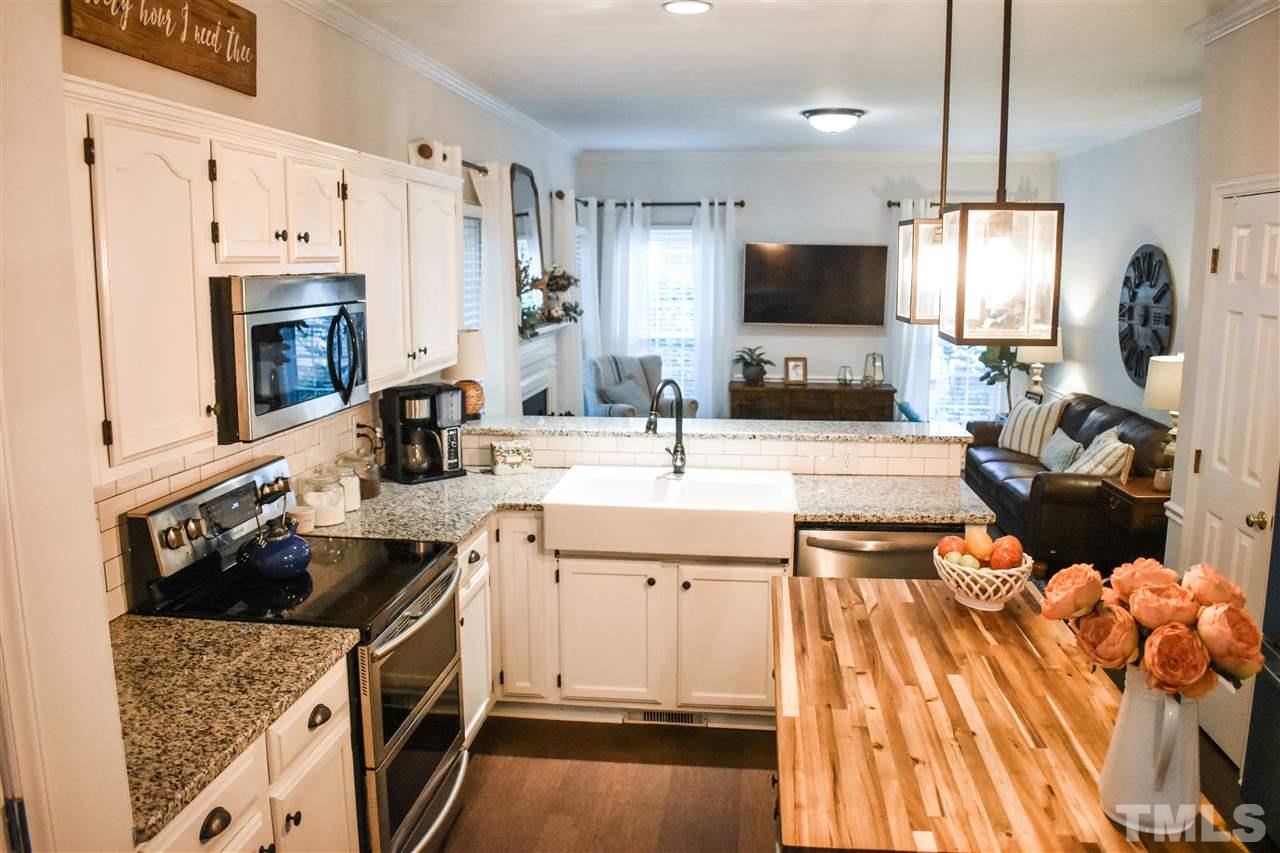 3417 Tunas Street Raleigh, NC 27616 - Photo 12 of 30 a kitchen with a sink stove and refrigerator