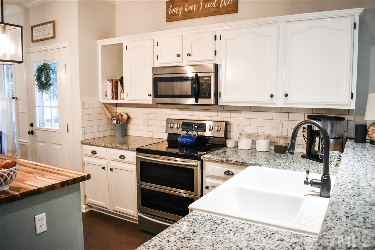 3417 Tunas Street Raleigh, NC 27616 - Photo 13 of 30 a kitchen with stainless steel appliances granite countertop a sink stove and microwave