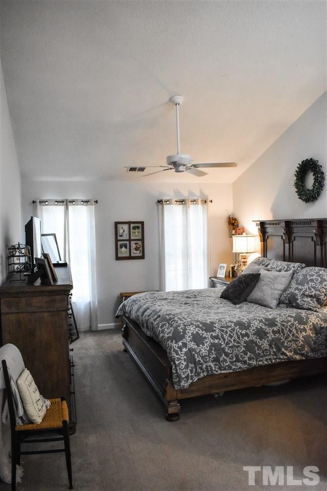 3417 Tunas Street Raleigh, NC 27616 - Photo 19 of 30 a bedroom with a bed and wooden floor