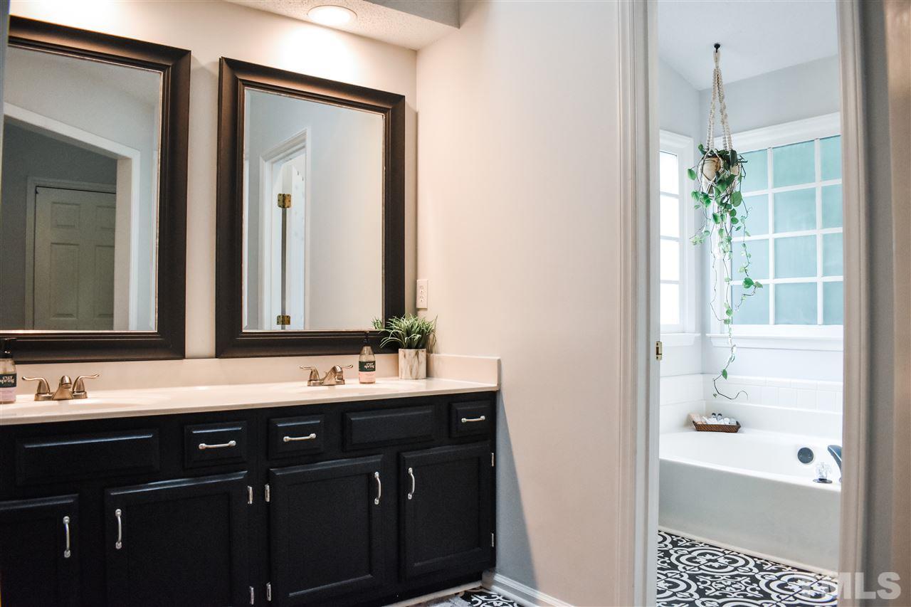 3417 Tunas Street Raleigh, NC 27616 - Photo 20 of 30 a bathroom with a bathtub a sink and a mirror