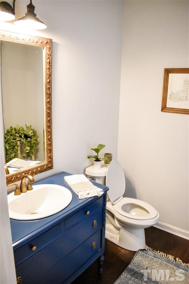 3417 Tunas Street Raleigh, NC 27616 - Photo 3 of 30 a bathroom with a toilet a sink and mirror