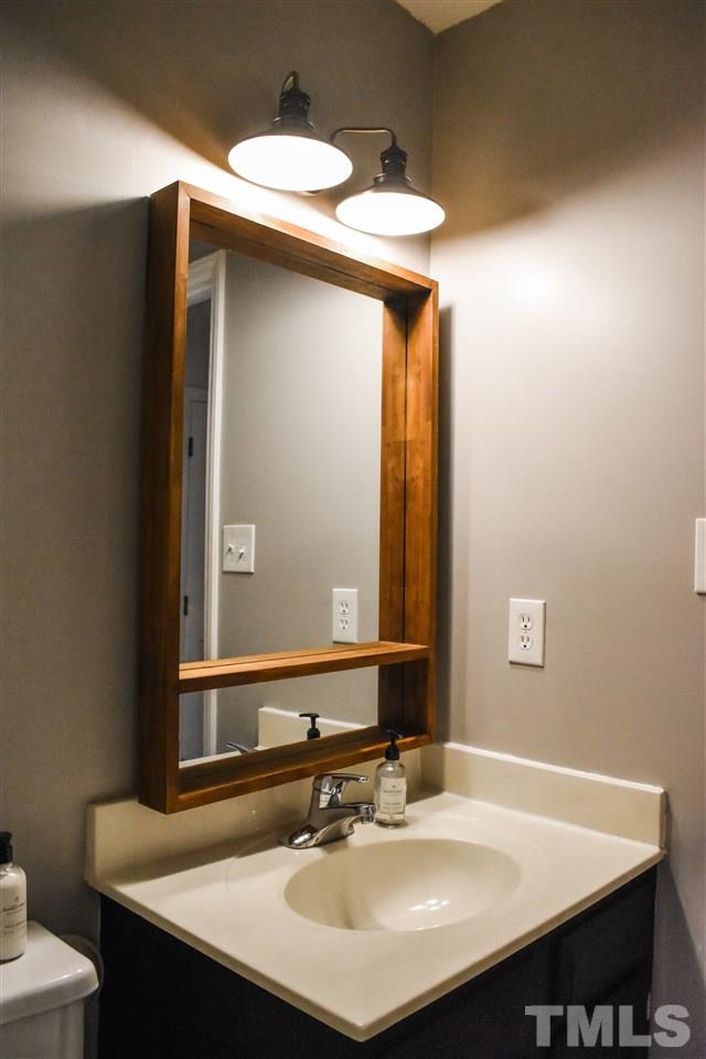 3417 Tunas Street Raleigh, NC 27616 - Photo 28 of 30 a bathroom with a sink and a mirror