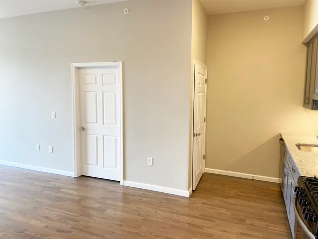 an empty room with wooden floor and a window
