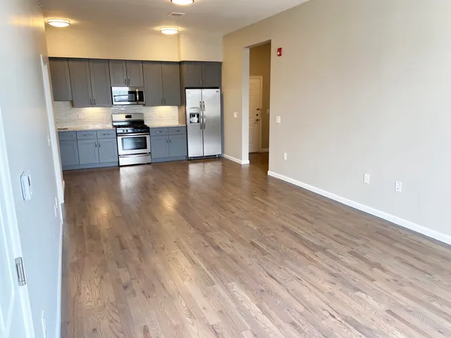 a kitchen with stainless steel appliances a refrigerator and a stove top oven
