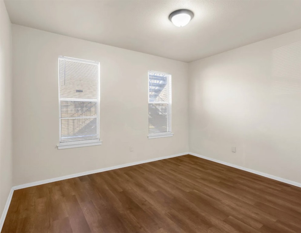 2012 West Loop Austin, TX 78758 - Photo 14 of 16 a view of an empty room with wooden floor and a window