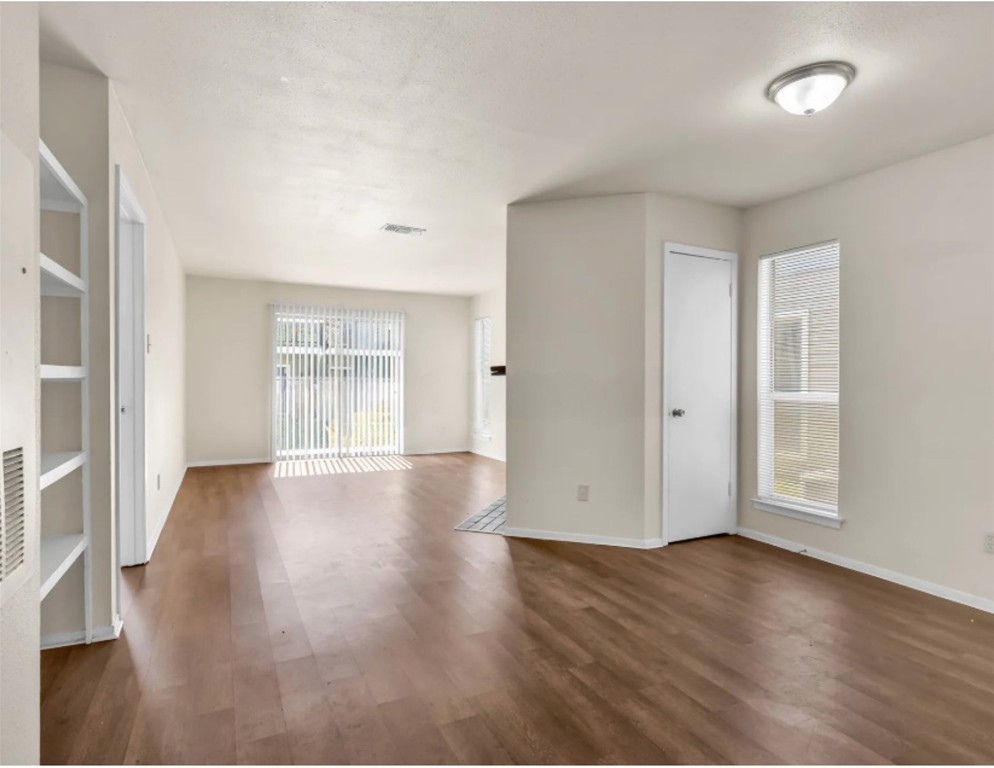 2012 West Loop Austin, TX 78758 - Photo 4 of 16 an empty room with wooden floor and windows