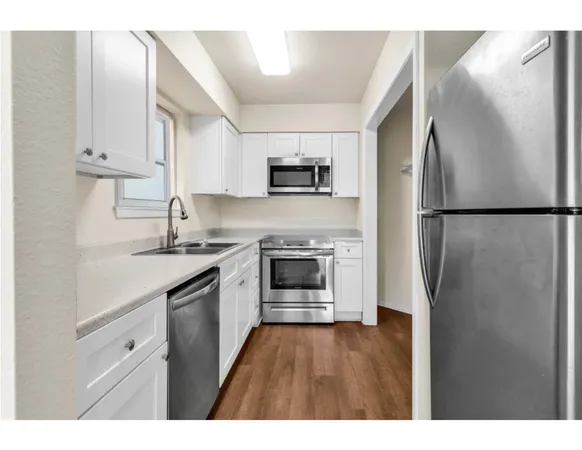 a kitchen with a refrigerator sink and stove