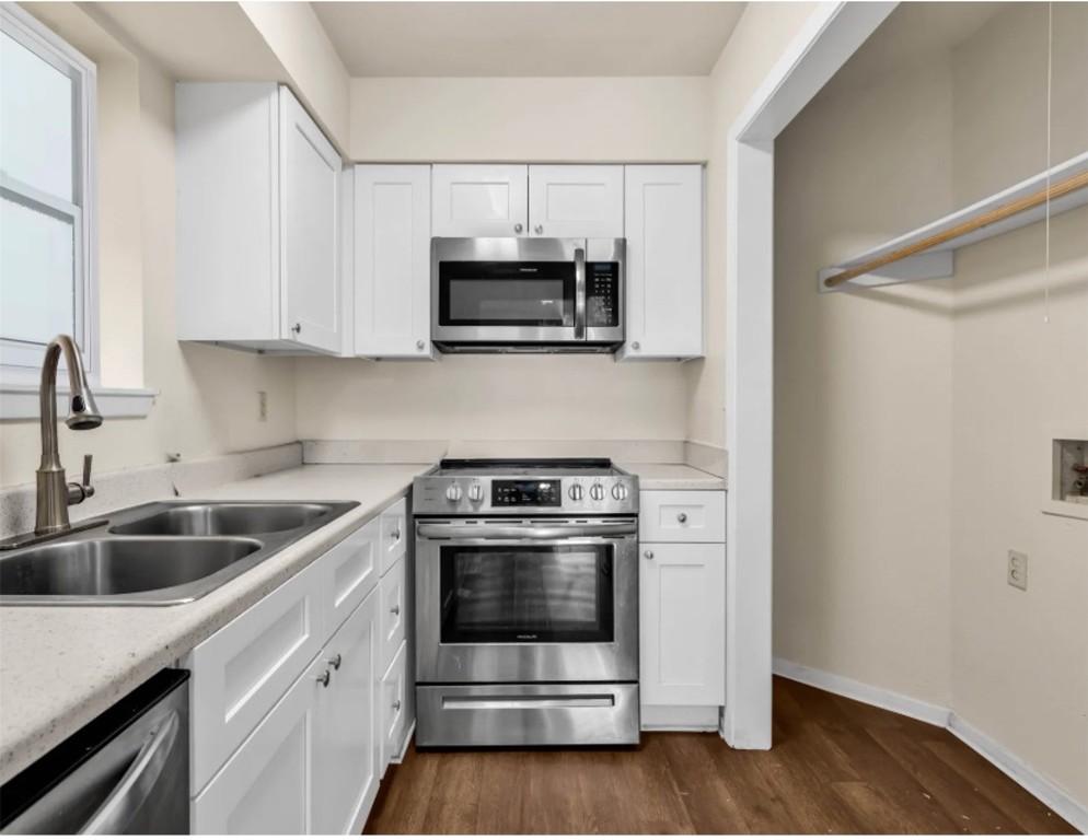 2012 West Loop Austin, TX 78758 - Photo 6 of 16 a kitchen with stainless steel appliances granite countertop a sink and a stove