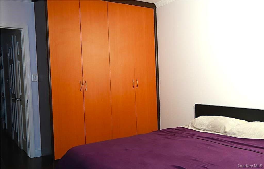 71-38 147th Street, Unit 27A Queens, NY 11367 - Photo 6 of 8 Bedroom featuring ornamental molding and a closet