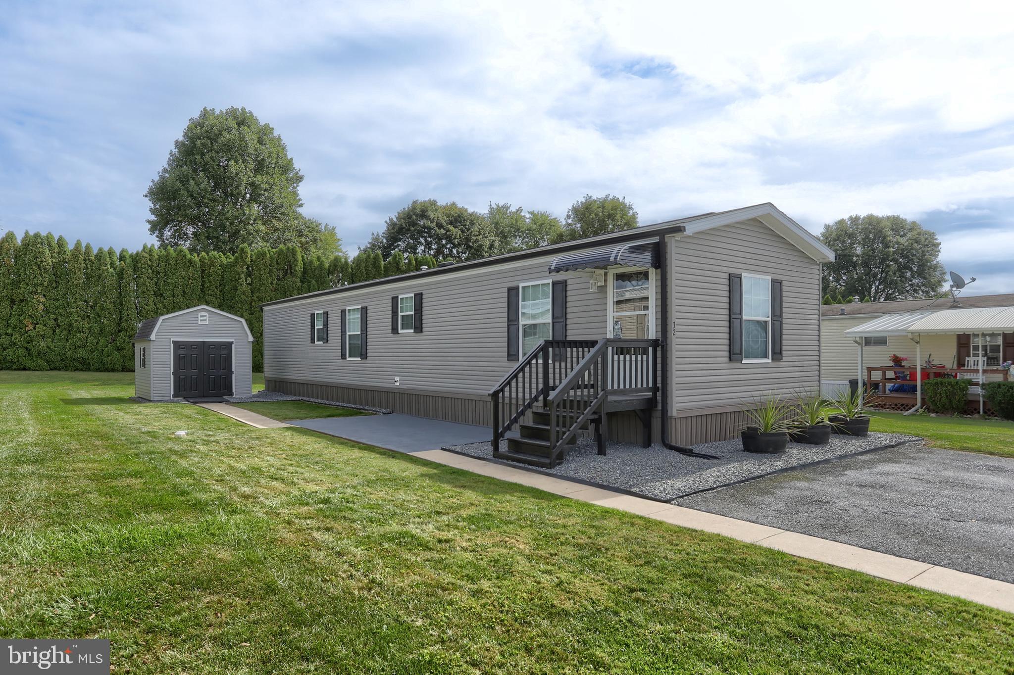 1300 East Kercher Avenue, Unit 32 Myerstown, PA 17067 - Photo 1 of 27 a backyard of a house with table and chairs floor to ceiling window